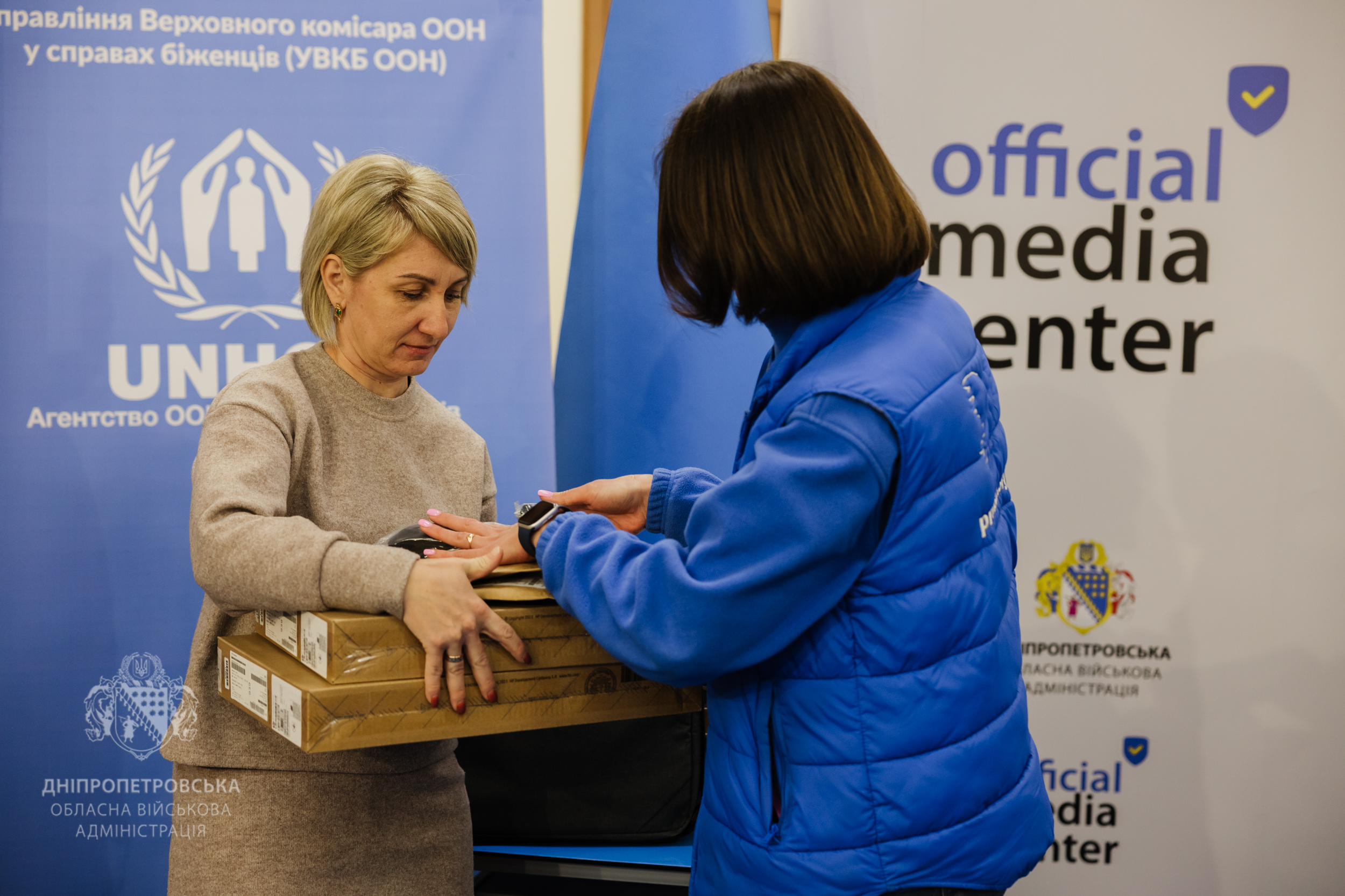 Представник організації вручає ноутбуки
